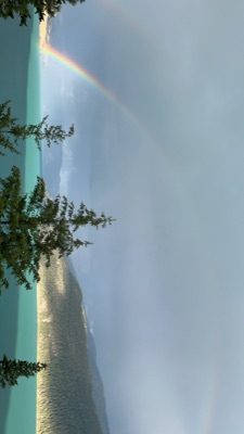 A rainbow over the still lake